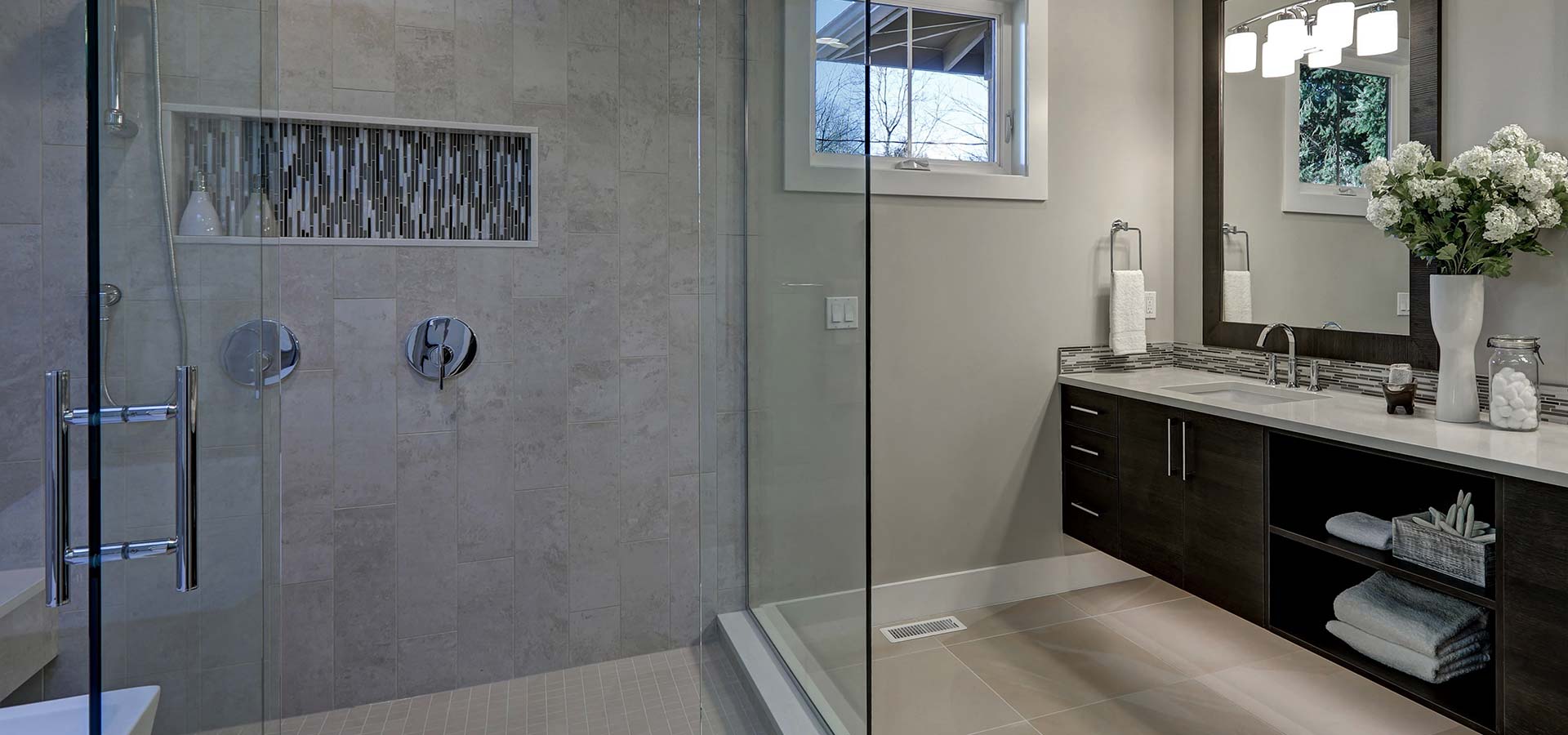 Bathroom Shower and Mirrors and Flowers on Countertop